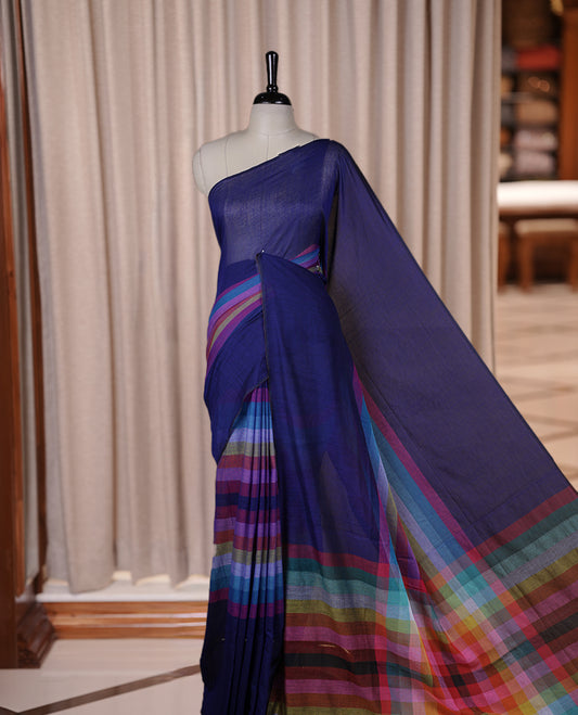 Navy blue colour soft cotton saree with rainbow colored horizontal lines on the body, a vibrant multicolor pallu, and a subtle border & Elegant and lightweight, this saree comes without a blouse piece for a customizable style.