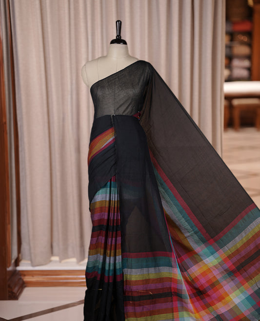 Black colour soft cotton saree with rainbow colored horizontal lines on the body, a vibrant multicolor pallu, and a subtle border & Elegant and lightweight, this saree comes without a blouse piece for a customizable style.