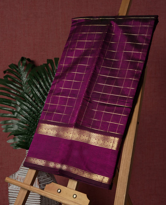 Deep Magenta colour pure Kanchi cotton saree featuring with delicate golden checks on body, paired with a contrasting deep maroon zari woven border & Includes a matching blouse piece for a complete look.