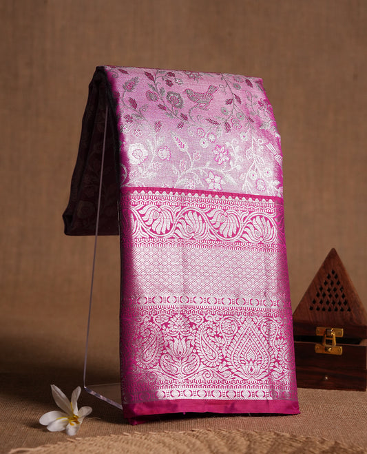 Bright pink colour and silver Zari Tissue Brocade Saree features intricate floral Motifs on body and dark pink contrast with silver traditional border & pallu, paired with matching blouse