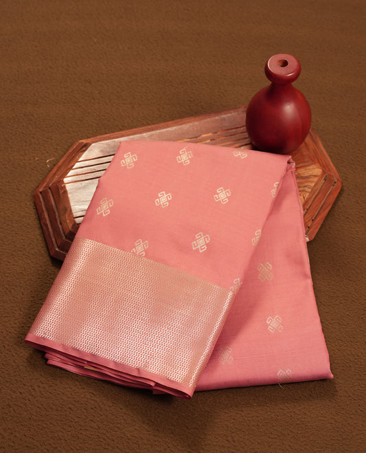 Dusty rose colour semi soft silk saree featuring a golden textured patterned body, complemented by self coloured golden zari motifes on pallu & border and a matching blouse piece.