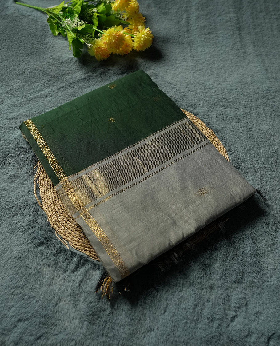 Deep Emerald Green and Silver Grey colour Silk Cotton Saree with Tiny Gold Zari Star Buttas on the Body, Slim Floral Zari Borders, Broad Silver Tissue Panel across the Pallu with subtle stripes, and a Plain Silver Grey Blouse with Matching Border