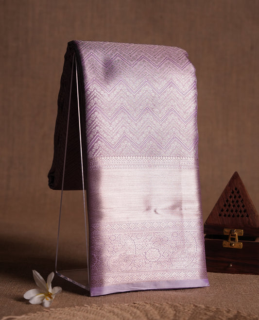 Light Lavender colour and silver Zari Tissue Brocade Saree features intricate Zigzag Motifs on body and self coloured border & pallu, paired with matching blouse