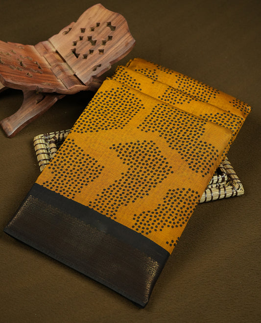 Mustard yellow colour chanderi cotton saree featuring black polka dot printed body,striped pallu with geometric patterns, golden zari border, and matching mustard yellow plain blouse.