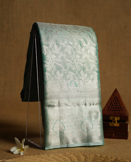 Light aqua green colour and gold Zari Tissue Brocade Saree features intricate floral Motifs on body and self coloured with traditional border & pallu, paired with matching blouse