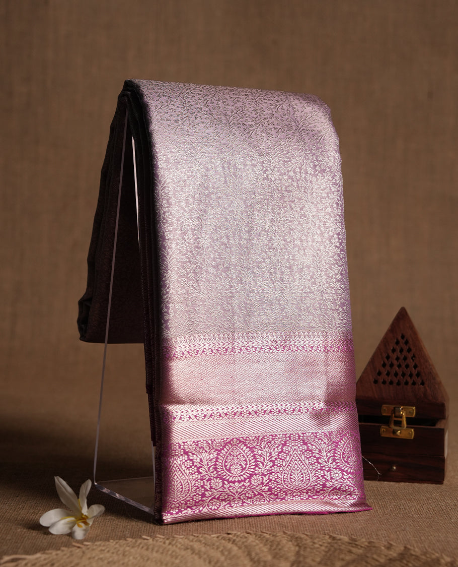 Light lavender colour and silver Zari Tissue Brocade Saree features intricate floral Motifs on body and dark pink colour contrast with traditional border & pallu, paired with matching blouse