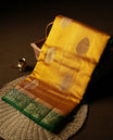 Golden Yellow Colour Banaras Soft Silk Saree with Gold Zari Textured Oval Buttas, Simple Decorative Pallu Border, Grand Pallu with Ornate Floral and Foliate Motifs in Green and Gold Tones, and Matching Forest Green Blouse.