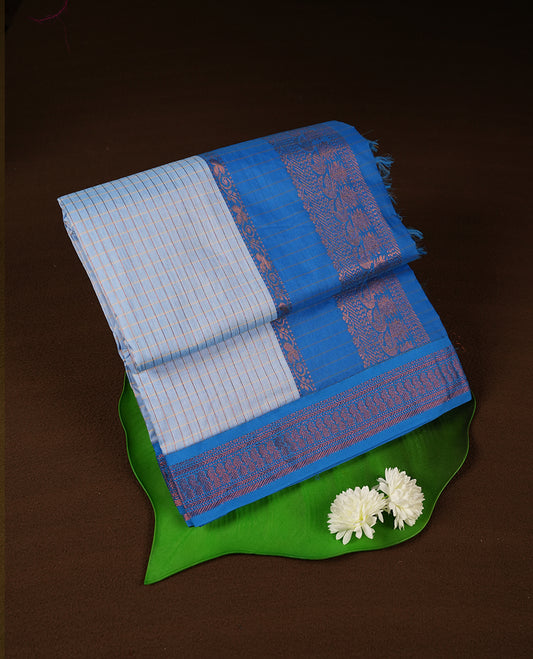 Sky blue coloured mixed Kalyani cotton saree featuring copper zari checks on the body, complemented by a bright blue coloured border and pallu adorned with copper zari patterns, Paired with a matching blouse.