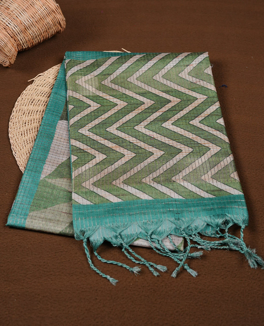 Green colour semi tussar silk saree featuring zigzag print and zari check pattern across body, self colour border with geometric pattern and pallu, paired with matching blouse piece.