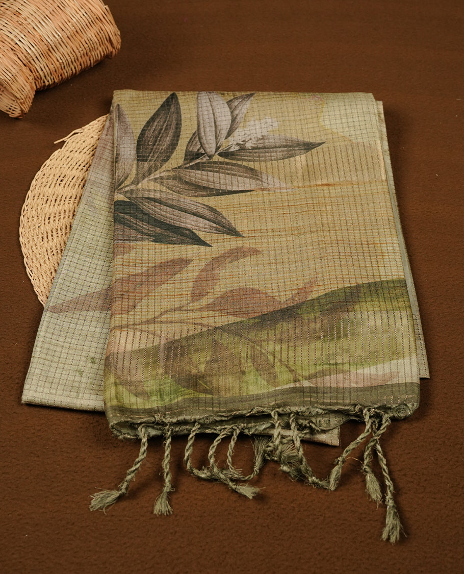 Green colour semi tussar silk saree featuring floral print and zari check across body, contrast dark green colour border and pallu, paired with matching blouse piece.