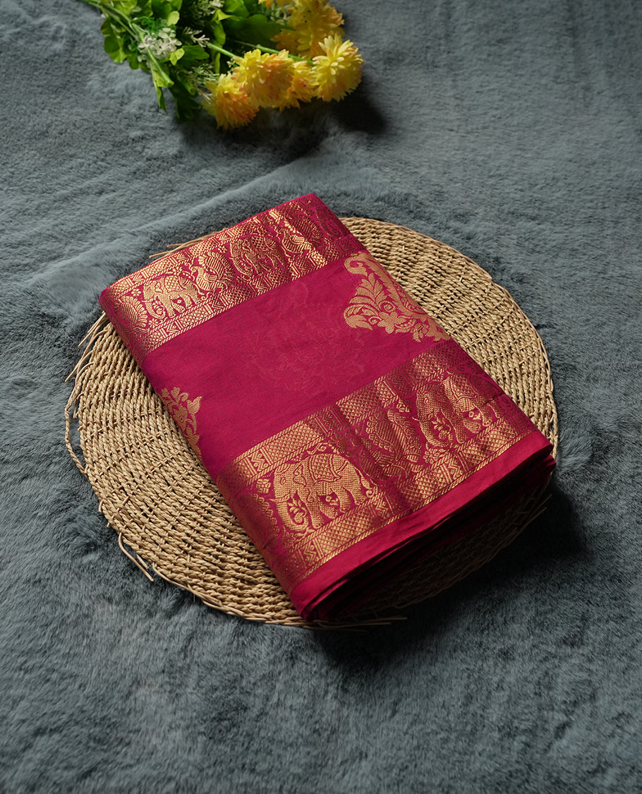 Maroon Colour silk cotton saree with gold zari elephant and floral design on the border, contrast pallu with traditional motifs, and a coordinated maroon blouse carrying the same rich zari border.