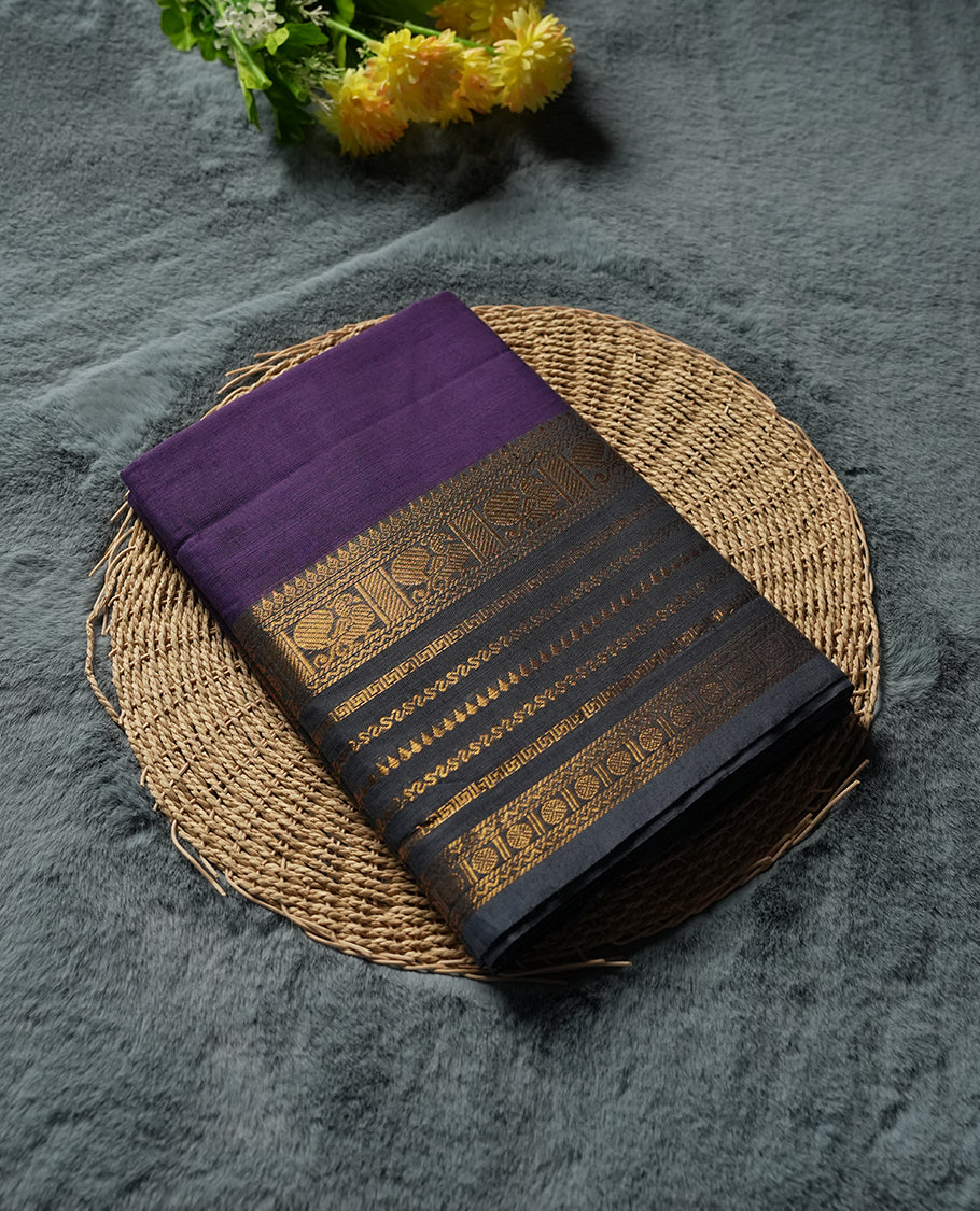Royal Purple colour Silk Cotton Saree with Antique Gold Zari Border Showcasing Peacock Motifs and Geometric Stripes, Simple Body, Rich Pallu with Gold Stripes, and a Coordinated Matching Blouse Piece