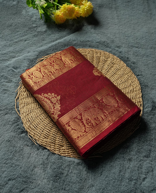 Maroon colour Silk Cotton Saree with Antique Gold Zari Borders Showcasing Elephant and Peacock Motifs, Subtle Self-Weave on the Body, and a Coordinated Matching Blouse Piece
