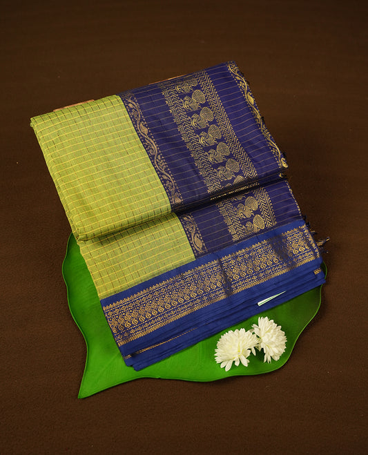 Lime Green coloured mixed Kalyani cotton saree featuring golden zari checks on the body, complemented by a royal blue coloured border and pallu adorned with golden zari patterns, Paired with a matching blouse.
