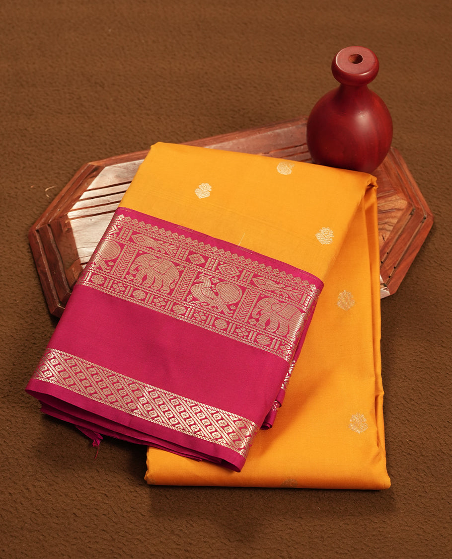 Mustard yellow colour semi soft silk saree featuring a gold coloured textured patterned body, complemented by contrast maroon golden traditional motifes on pallu & border and a matching blouse piece.