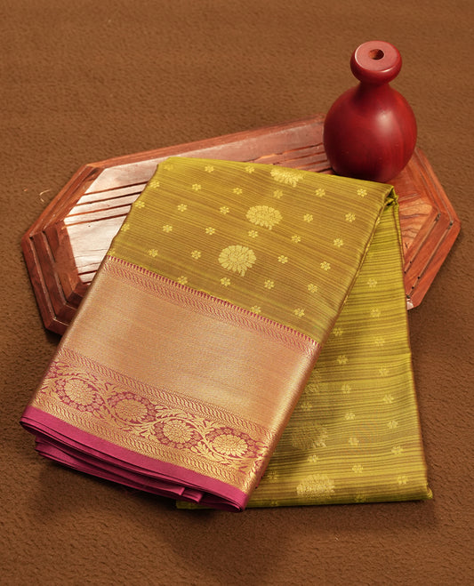 Antique Bronze colour semi soft silk saree featuring a gold colour textured patterned body, complemented by contrast magenta with golden motifes on pallu & border and a matching blouse piece.