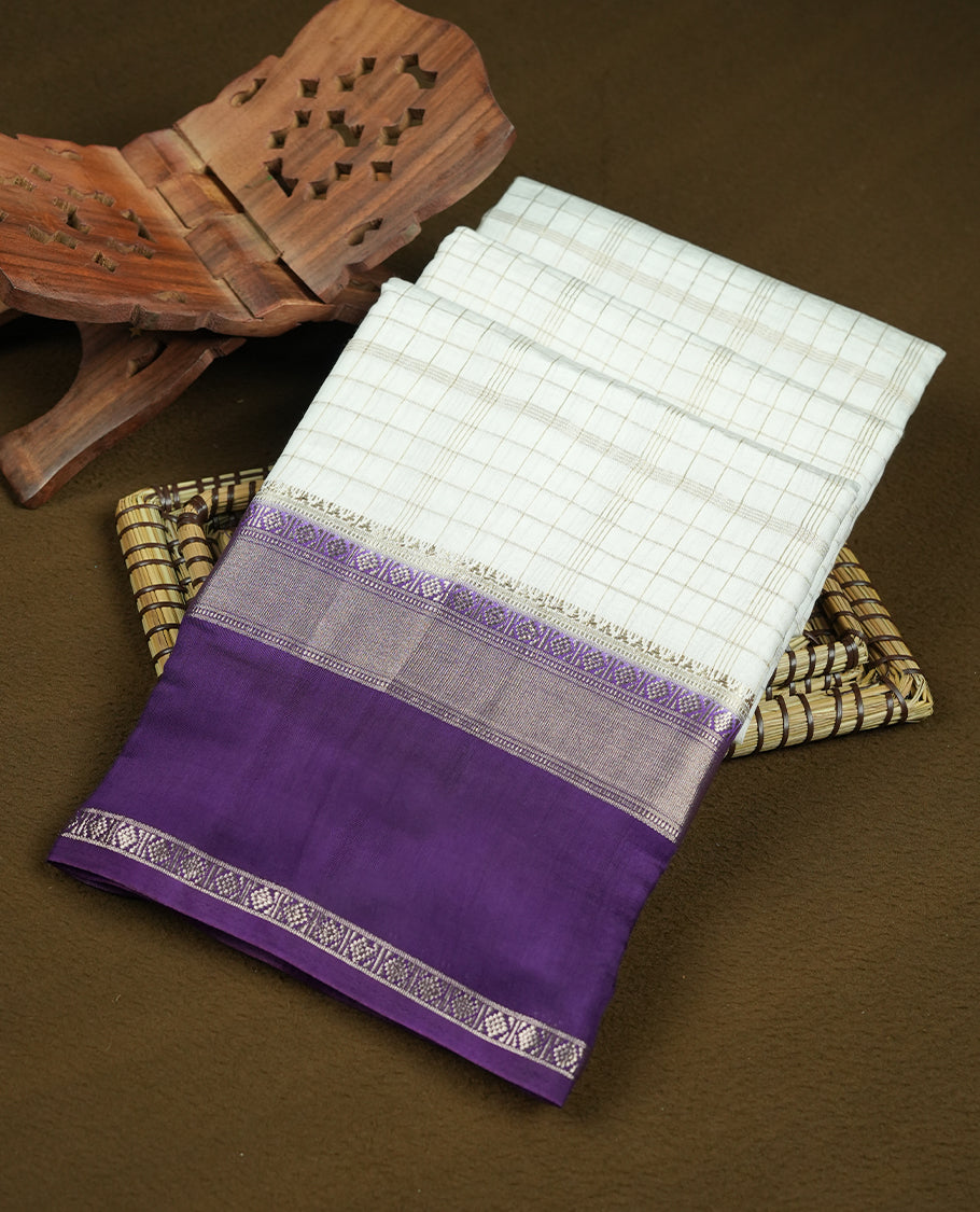 White colour mixed chanderi cotton saree with checkered body, deep purple pallu with rose gold zari border, and matching purple blouse.