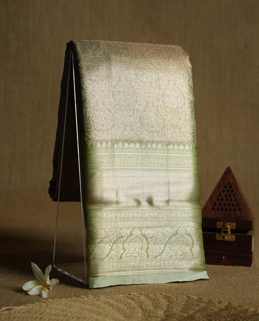 Golden green colour and rose gold Zari Tissue Brocade Saree features intricate floral Motifs on body and pastel green colour contrast  border with traditional border & pallu, paired with matching blouse