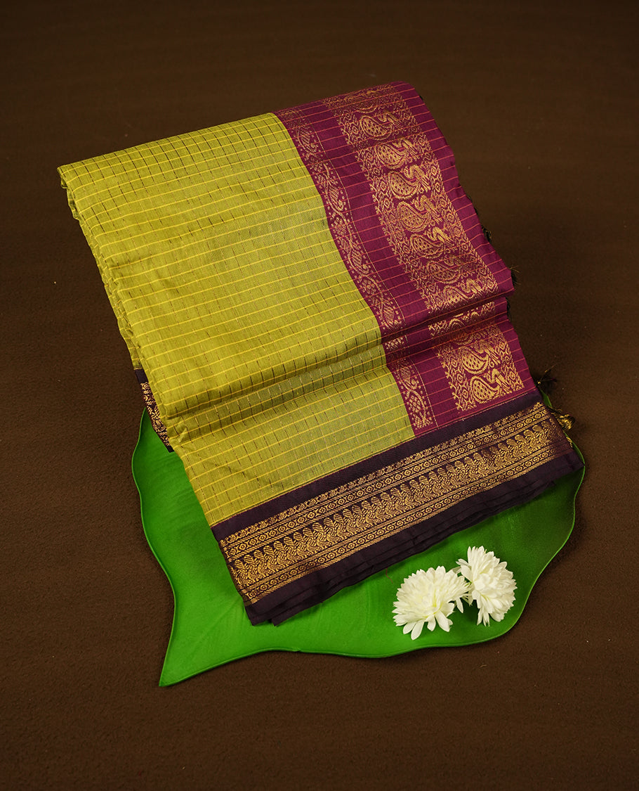 Yellow Green coloured mixed Kalyani cotton saree featuring golden zari checks on the body, complemented by a burgundy coloured border and pallu adorned with golden zari patterns, Paired with a matching blouse.