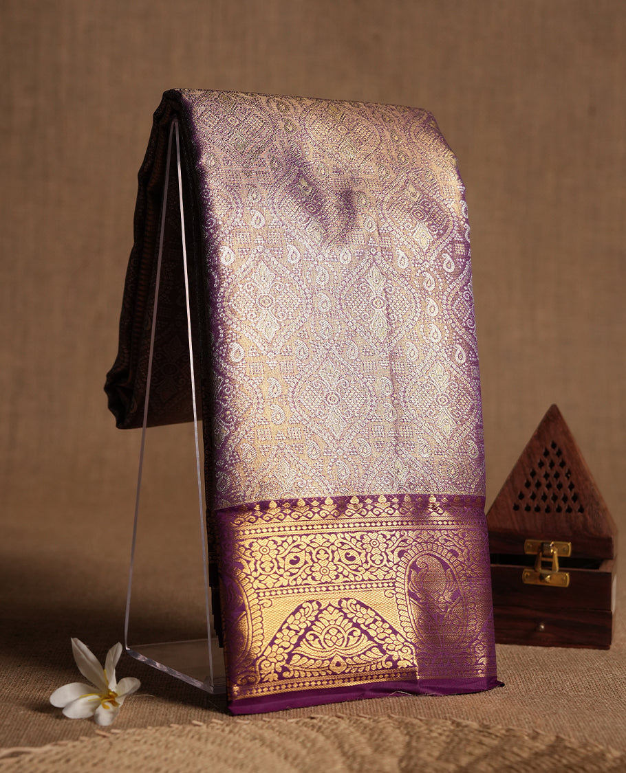 Purple colour and gold & silver Zari Tissue Brocade Saree features intricate Motifs on body and dark magenta contrast border with gold traditional pallu, paired with matching blouse