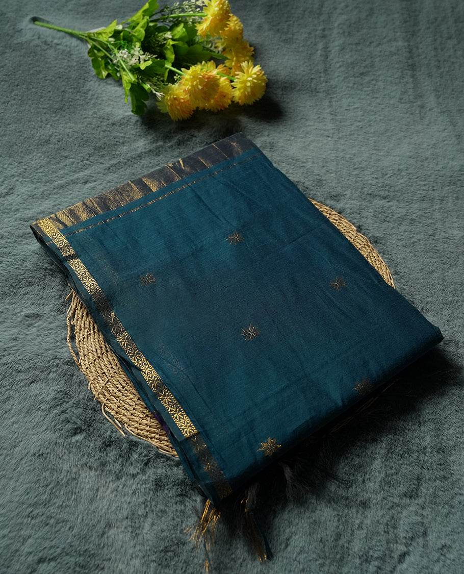 Teal Blue Colour silk cotton saree featuring small zari buttas on the body, contrast purple section, zari pallu, and matching blouse with border detailing.