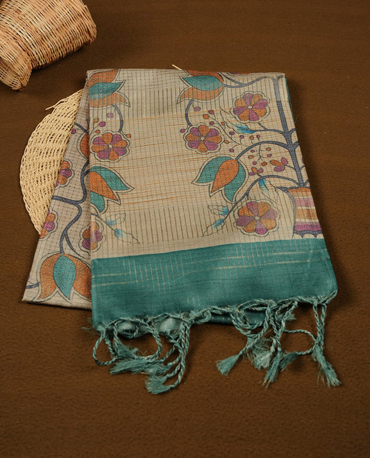 Wheat colour semi tussar silk saree featuring floral print and zari check pattern across body, contrast green colour border and pallu, paired with matching blouse piece.