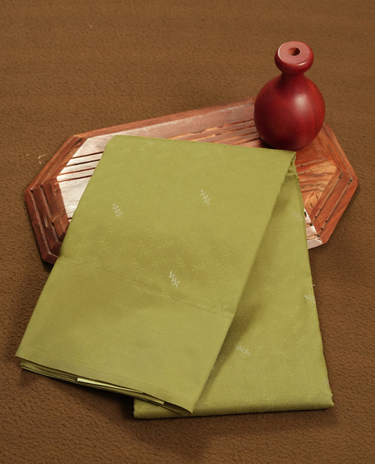 Khaki green colour semi soft silk saree featuring a self coloured textured patterned body, complemented by self coloured plain pallu & border and a matching blouse piece.
