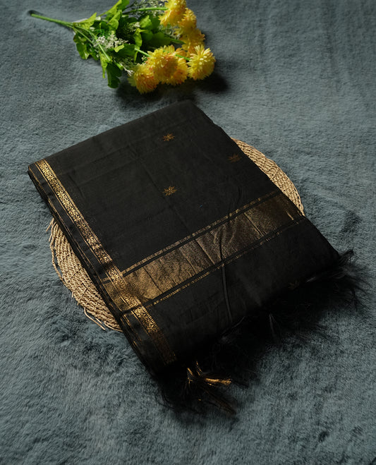 Black colour Silk Cotton Saree with Tiny Gold Zari Star Buttas on the Body, Antique Gold Tissue Panel on the Pallu, Slim Floral Zari Borders, and a Plain Black Blouse with Matching Border