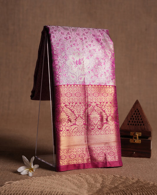Magenta colour and gold & silver Zari Tissue Brocade Saree features intricate floral Motifs on body and dark red contrast border & pallu with traditional pattern, paired with matching blouse
