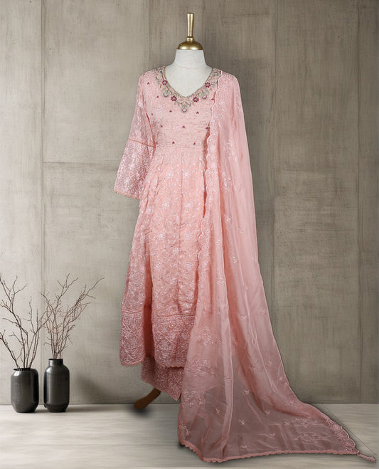 Baby pink colour salwar from TWARA, featuring a delicate embroidered V neck with floral thread work, all over chikankari style embroidery on the top, paired with a matching bottom and an elegant sheer dupatta.