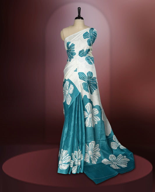 Sky blue colour saree with off white floral motifs and subtle , exuding timeless elegance and modern charm & paired with a matching blouse.