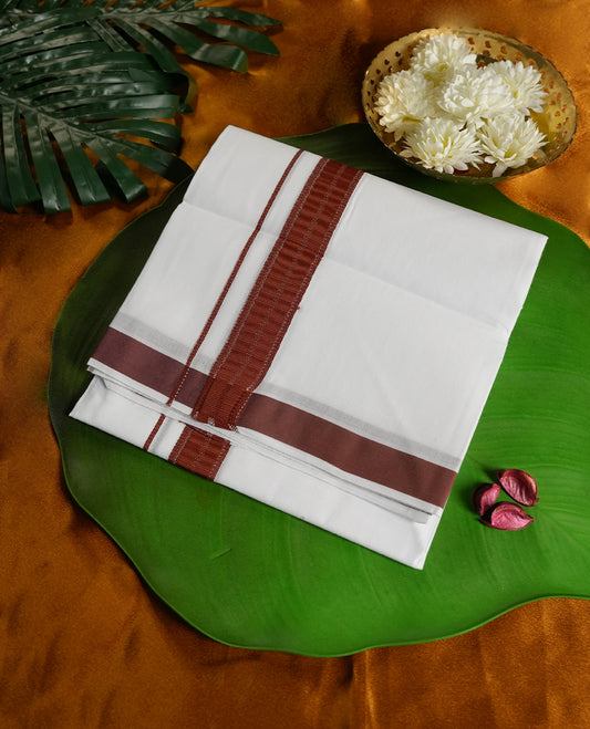 White colour cotton dhoti enhanced with a rust maroon border and fine woven detailing, offering a timeless traditional appeal & Perfect for cultural functions, festive wear, and auspicious occasions.