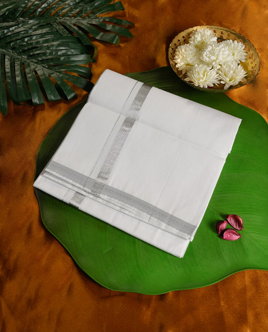 White colour cotton dhoti featuring a refined silver zari border, adding a touch of sophistication and charm & A perfect choice for temple visits, weddings, and traditional festive occasions.