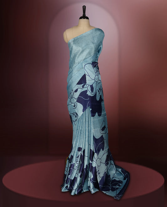 Sky blue colour saree with bold navy floral prints across the body and pallu.,Crafted in soft, lightweight fabric for an elegant drape, Paired with matching blouse.