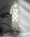 Off white colour cord set with green Warli inspired prints, featuring a round neckline straight kurta with 3/4th sleeves and front slit, paired with matching printed straight pants.