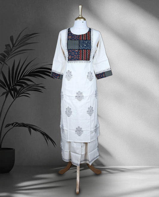 Cream colour cotton cord set with navy blue floral prints, highlighted by vibrant patchwork on the yoke and sleeve borders, Paired with matching straight pants.