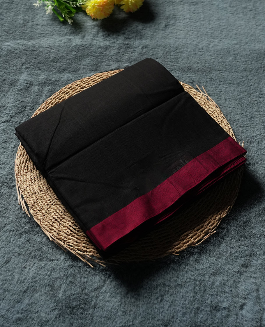 Black colour Narayanapattu cotton saree featuring a self coloured body, maroon coloured zari pattern border and maroon striped colour pallu, pairing a matching blouse piece.