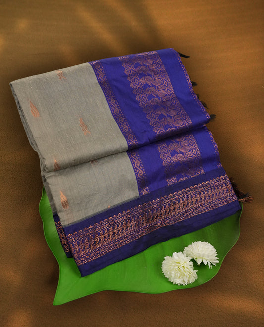 Grey colour Kalyani Cotton saree with royal blue border and pallu, adorned with copper zari motifs and intricate weaving & Comes with a matching blouse piece.