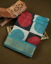 Teal and coral red colour mixed chanderi cotton saree with checkered body featuring circle motifs, geometric printed pallu, golden zari border, matching teal blouse