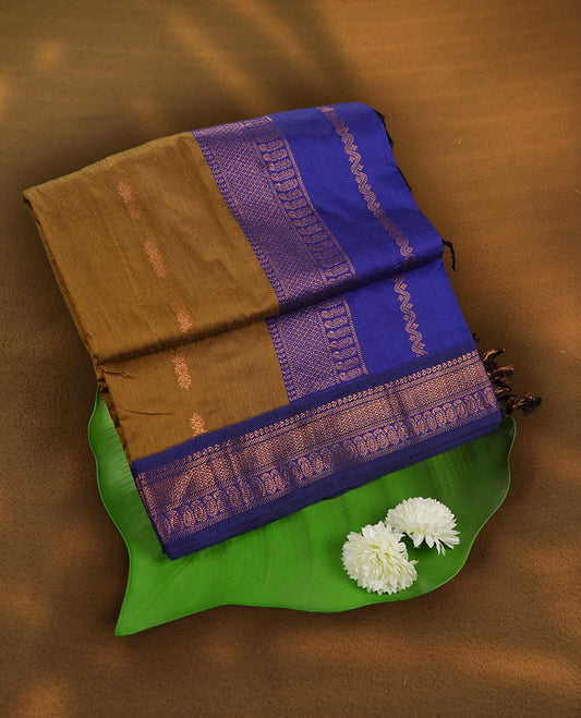 Dark golden yellow and royal blue Kalyani cotton saree featuring delicate zari butta work on the body, highlighted with an elegant contrast zari woven border & Paired with a matching blouse.