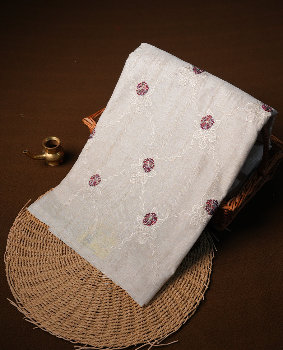 Cream colour semi tuseer silk saree featuring with Self colour thread embroidery kodi pattern & brown colour floral thread motifs all over body, pallu, and paired with matching blouse piece.