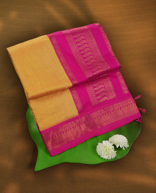 Royal yellow colour Kalyani cotton saree with vibrant pink contrast zari border, beautifully adorned with intricate weaving & Paired with blouse.