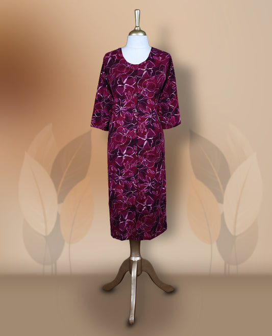 Magenta colour kurti featuring a round neckline with button detailing, 3/4th sleeves, and an all over floral print in pink and beige, designed in a straight cut silhouette for a simple and elegant everyday look.