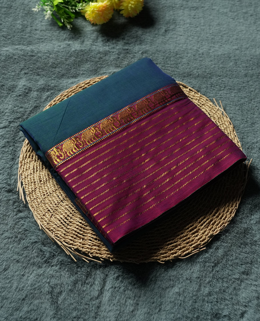 Peacock Blue colour Narayanapattu cotton saree featuring a self coloured body, maroon coloured with gold zari pattern border and gold striped colour pallu, pairing a matching blouse piece.