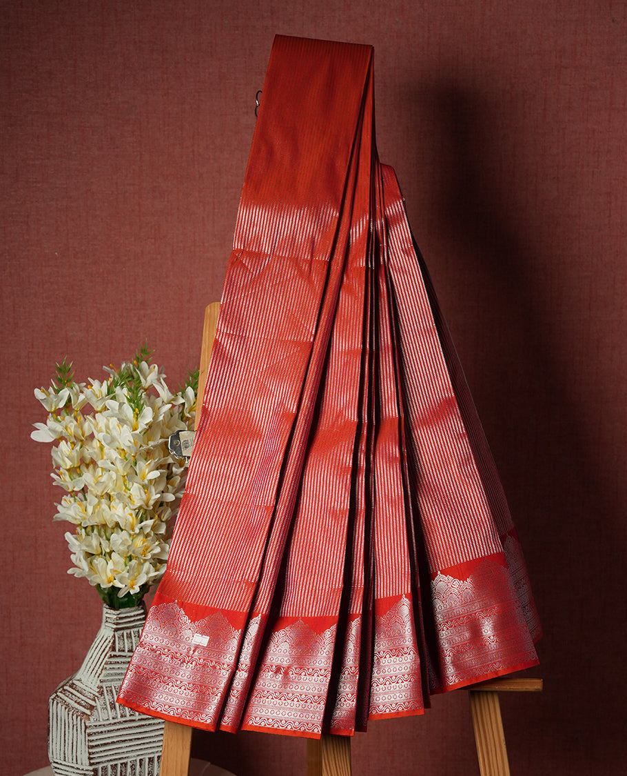 Tomato Red Colour Semi Silk Saree with Silver Striped Body, Self Coloured Silver Zari Pallu & Border, Ornate Scallop Motifs, and Matching Blouse Piece