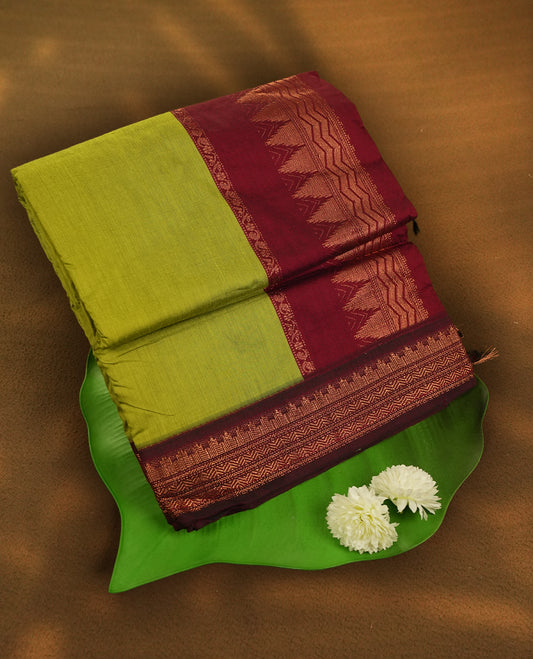 Lemon green colour Kalyani Cotton saree with rich maroon colour border with temple motifs on  pallu, featuring copper zari and intricate weaving & Includes a matching blouse piece.