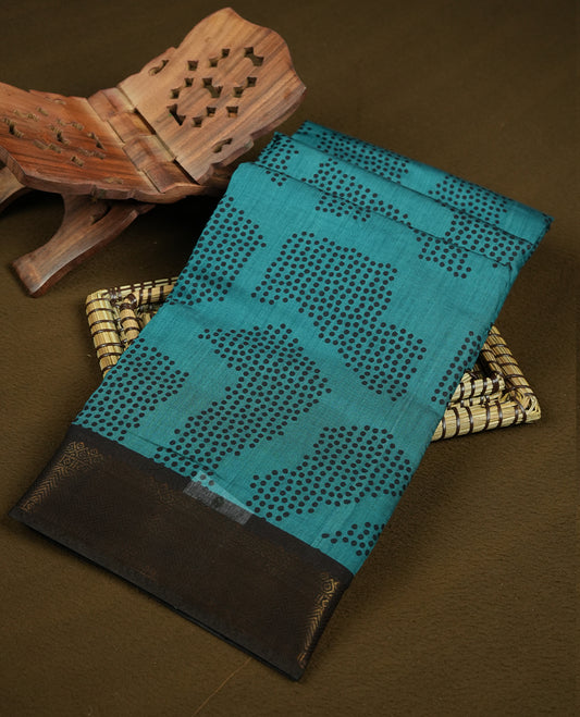 Dark teal colour mixed chanderi cotton saree with black dot motifs, multicolor striped pallu with black, off-white and turquoise triangle geometric pattern, golden zari border, and matching blouse.
