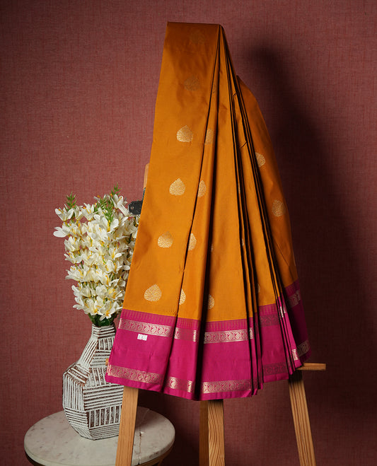 Orange Colour Semi Silk Saree with Golden Paisley Butta Motifs, Contrasting Hot Pink Golden Zari Pallu & Border, Geometric Patterns, and Matching Blouse Piece