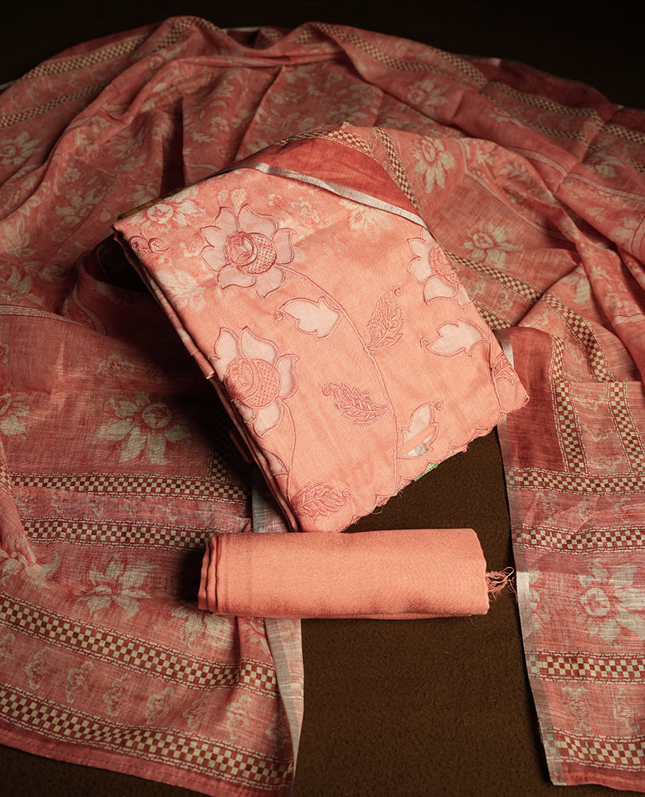 Peach colour churidhar material featuring cutwork and thread embroidery on the front panel, floral digital printed dupatta with elegant border, and matching plain bottom.