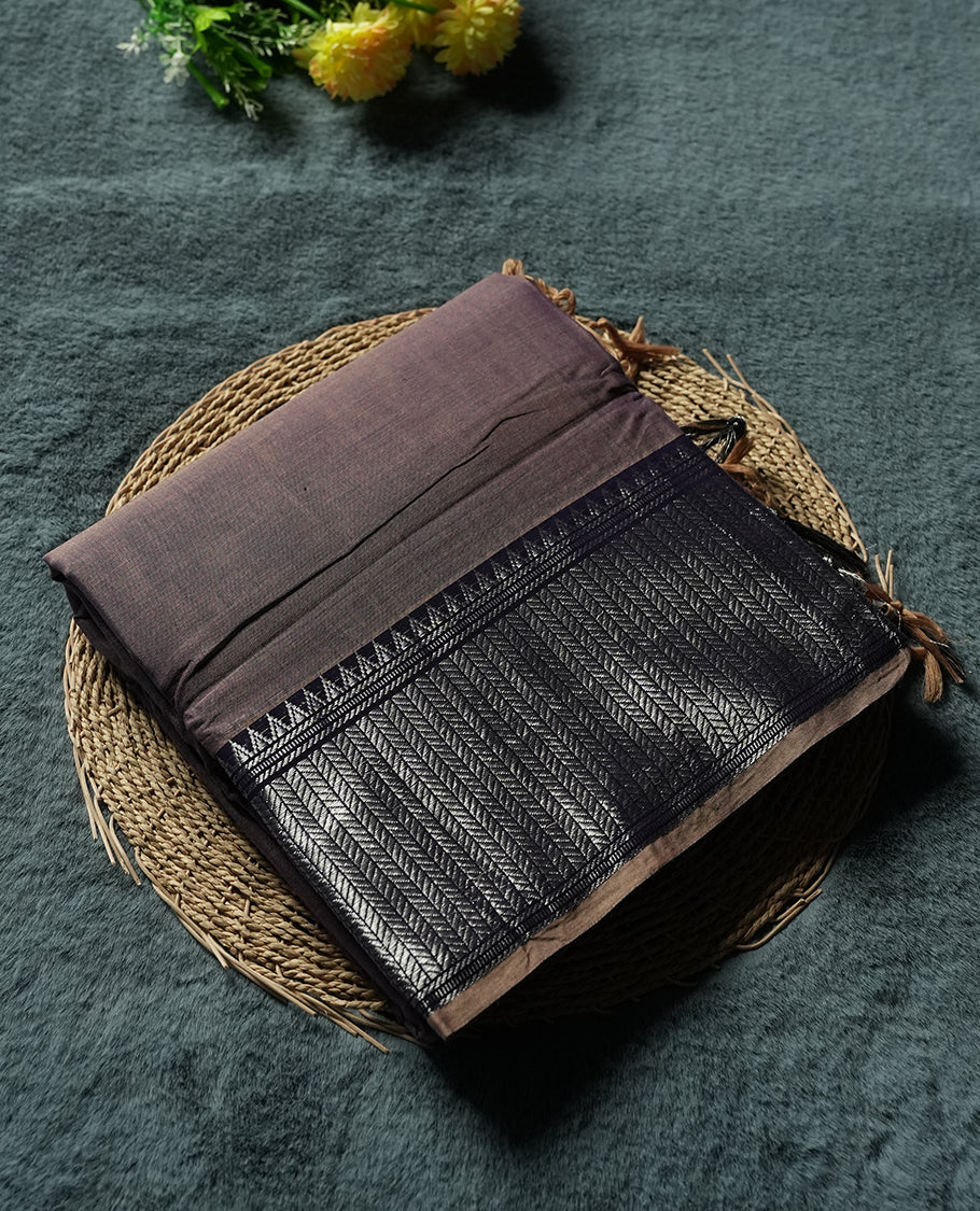 dark purple colour Narayanapattu cotton saree featuring a self coloured body, dark purple coloured with silver zari pattern border and ivory striped colour pallu, pairing a matching blouse piece.